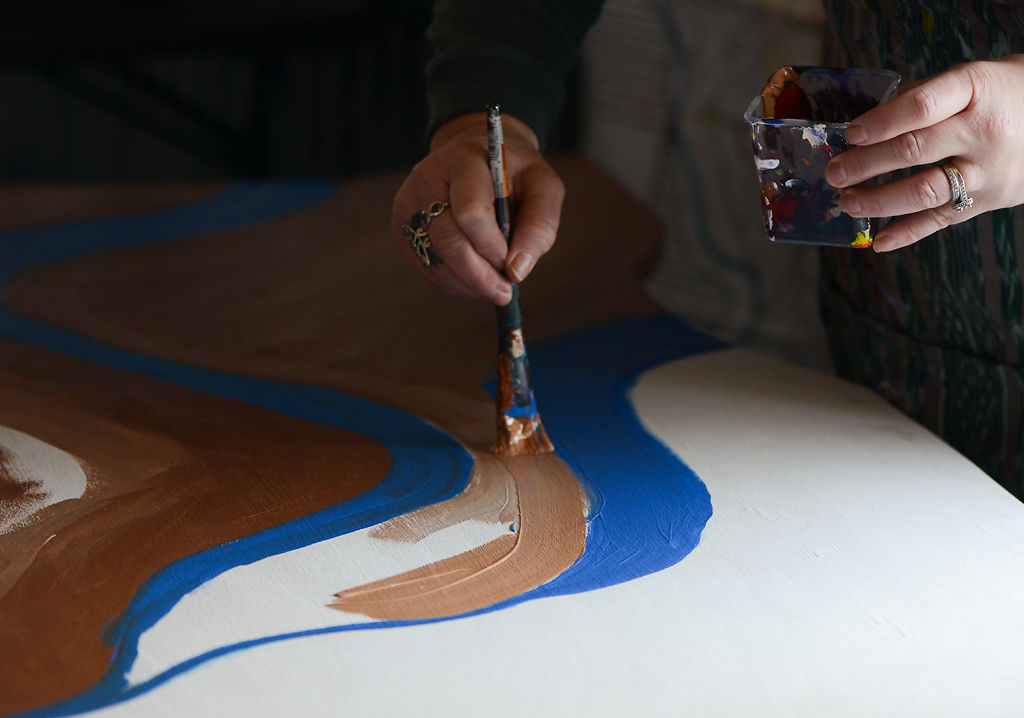 Clover Helmka paints a mural